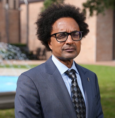 Photo of Lars Lerup, the former dean of the Rice School of Architecture, who has light-colored hair, a glasses and a beige blazer