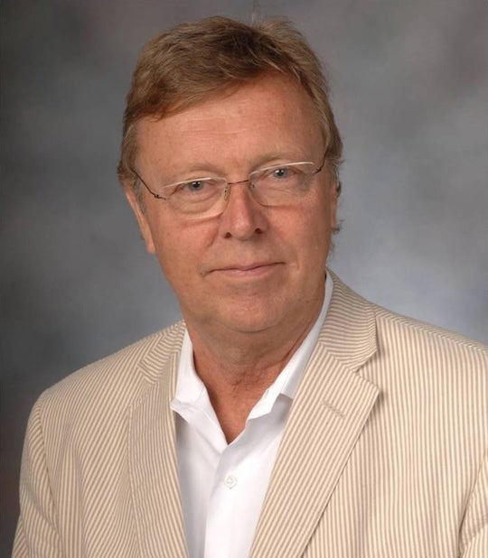Photo of Lars Lerup, the former dean of the Rice School of Architecture, who has light-colored hair, a glasses and a beige blazer